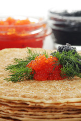 Russian pancakes with red and black caviar	