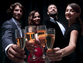 Cheerful people celebrating a sucess with Champagne