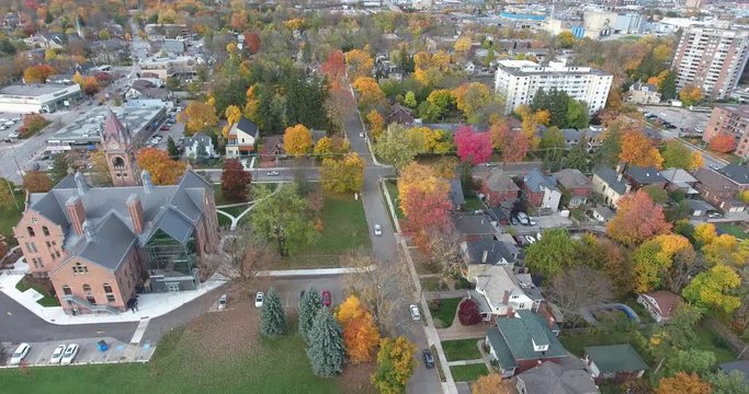 Flying By Clock Tower Church Skyscrapers With Autumn Trees Drone Aerial View