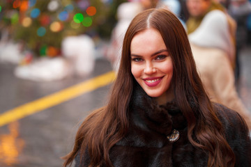 Young beautiful woman in mink fur coat