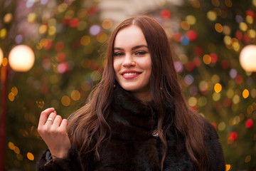 Young beautiful woman in mink fur coat