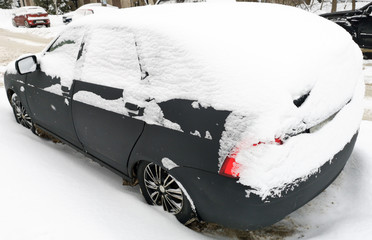 Auto covered with snow in winter