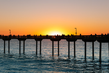 People are fishing and enjoying their sunset at Ocean Beach, San Diego, California
