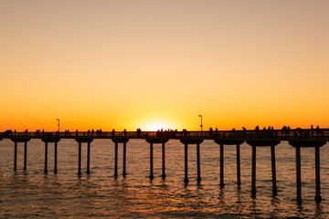 People are fishing and enjoying their sunset at Ocean Beach, San Diego, California