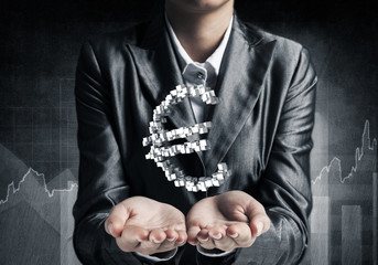 Businessman presenting euro symbol.