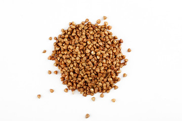 Pile of raw buckwheat seeds on a white background