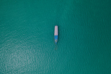 Boat in calm ocean seen from above