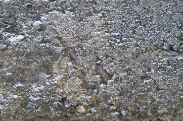 A fragment of concrete wall, covered with frost and snow.