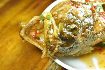 deep fried blacktip grouper fish dressing sweet chili sauce on plate