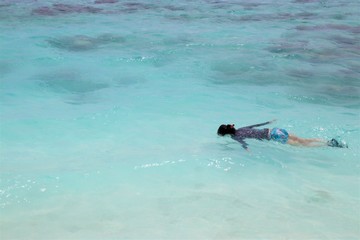 Woman snorkeling in beautiful sea in Maldive