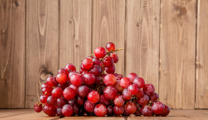 branch of ripe organic grapes on wooden rustic background