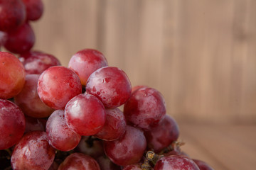 branch of ripe organic grapes on wooden rustic background