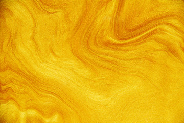 Golden acrylic background texture.