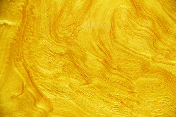 Golden acrylic background texture.