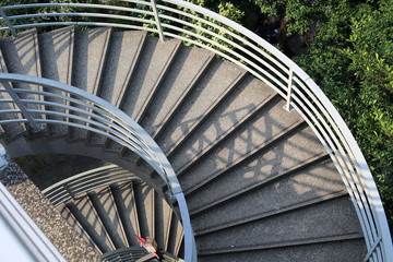 long spiral stair of footbridge with the sun ray light and shadow in daytime detail , in Central,...