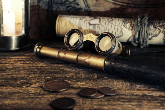 Pirate map.Ship lantern.Binoculars,monocles,spy glass.Travel and marine engraving background.Treasure hood concept.Old coins.Gold,silver.Numismatics and collecting money.Vintage style