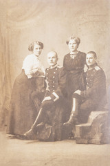 RUSSIA - CIRCA 1905-1910: An antique photo shows two soldiers with girlfriends posing in front of...