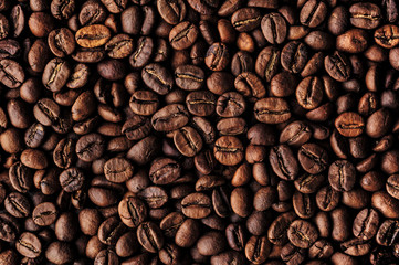 Roasted coffee beans heap, macro closeup