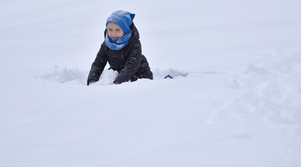 child playing in the snow