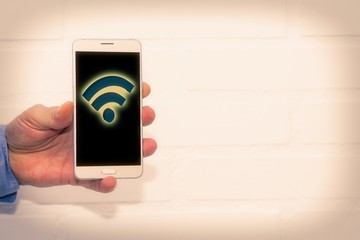 hand with mobile phone and wi-fi symbol