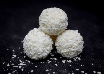 White chocolates coconut truffles. Delicious and sweet coconut candy. Close-up. Sweets