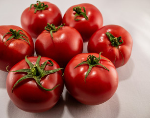 Red ripe tomatoes on white background