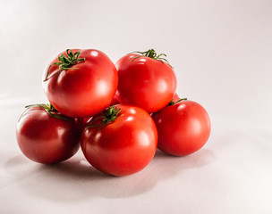 Red ripe tomatoes on white background