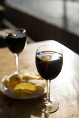 Spanish tapas with vermouth drink on a wooden table in a terrace