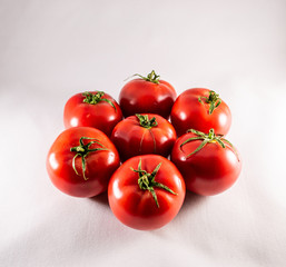 Red ripe tomatoes on white background