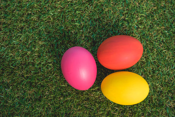 Fototapeta na wymiar Top view of Easter eggs clean on grass background