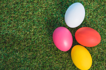 Fototapeta na wymiar Top view of Easter eggs clean on grass background
