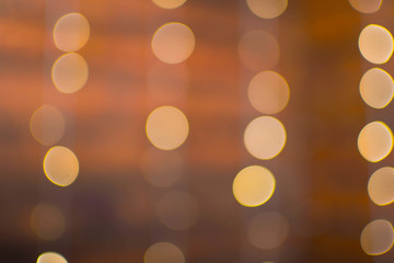 Out of focus texture background of Christmas tree with ornaments and Christmas lights.