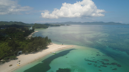 Aerial view of beautiful tropical beach with turquoise water in blue lagoon, Anguib, Philippines, Santa Ana. Ocean coastline with sandy beach, coral reefs. Tropical landscape in Asia.