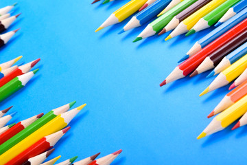 Colored pencils background.Color pencils on blue background.Close up. Many different colored pencils on blue background.Colorful pencil .Colorfull