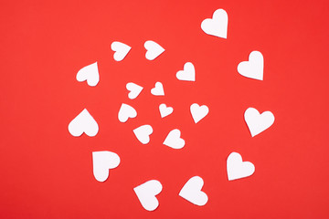 White hearts on vibrant red background.