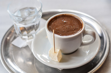 Turkish coffee with turkish delight on metal plate