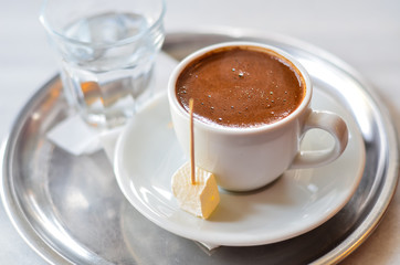 Turkish coffee with turkish delight on metal plate