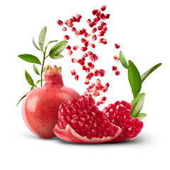 Fresh ripe pomegranate with green leaves isolated on white background.