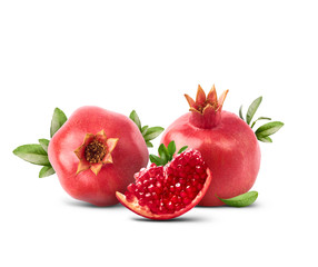 Fresh ripe pomegranate with green leaves isolated on white background.
