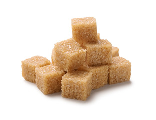 Heap of cane sugar cubes isolated on white background