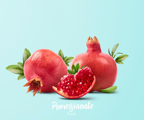 Fresh ripe pomegranate with green leaves isolated on white background.