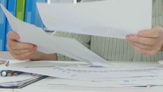 Businessman in Accounting Office Browse and Read Documents Pages