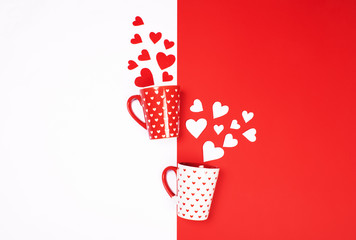Mugs with scattered hearts on red and white.