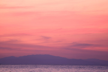 Stunning Pastel Pink and Purple Sunrise Sky over the Gulf of Thailand with the Mountain Range in the Backdrop 