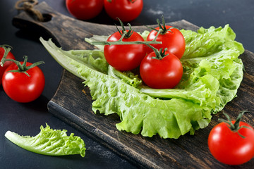 Tomatoes and lettuce on a wooden background