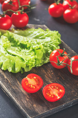 Tomatoes and lettuce on a wooden background
