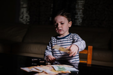 Little mobster with gun and money on the table 