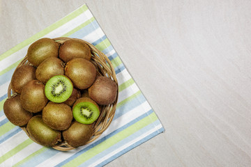 Top view of ripe kiwi fruits in a basket. Healthy nutrition concept.