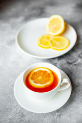 Tea, lemon, hot, drink. Tasty fragrant hot tea with a lemon on a concrete background