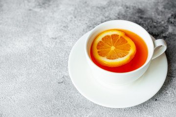 Tea, lemon, hot, drink. Tasty fragrant hot tea with a lemon on a concrete background